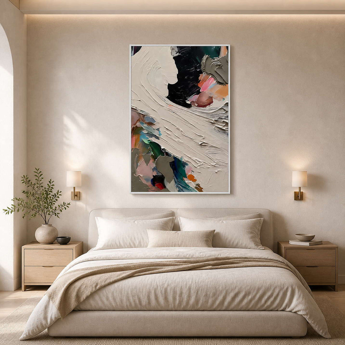 Sculptural ivory and black wall art above a serene neutral bedroom.