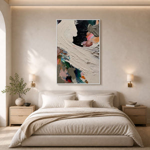 Sculptural ivory and black wall art above a serene neutral bedroom.