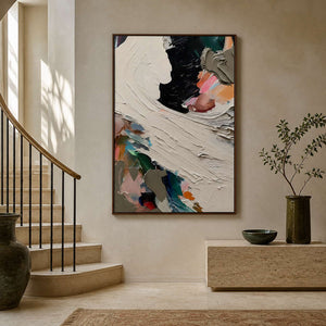 Colorful textured abstract canvas styled beside a sculptural entryway staircase.