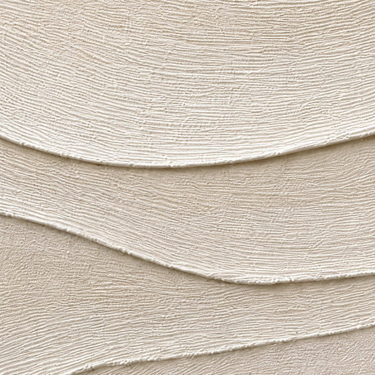Close-up of fine combed lines across layered ivory relief.