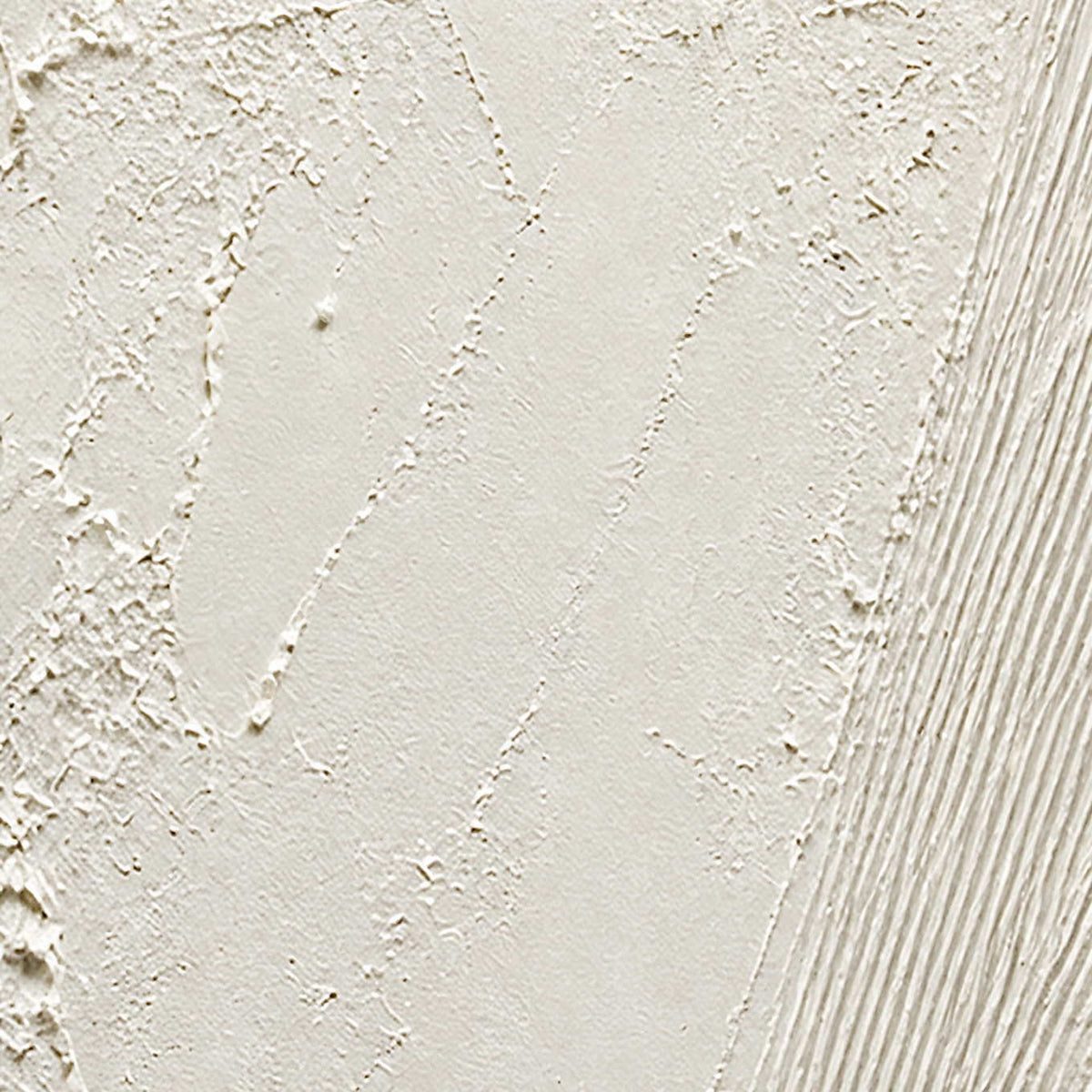 Close-up of rough ivory mineral texture and finely combed white lines.
