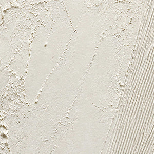 Close-up of rough ivory mineral texture and finely combed white lines.