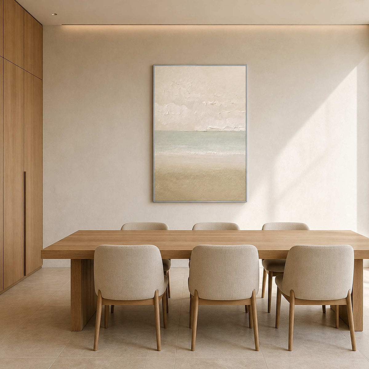 Soft coastal canvas displayed above a refined light wood dining table.