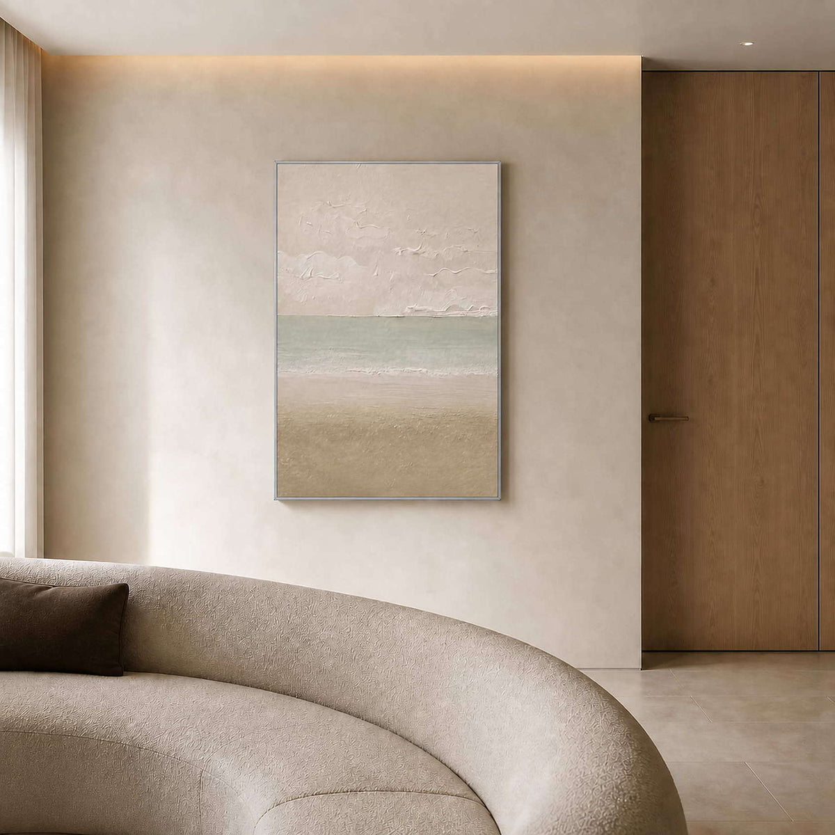 Textured horizon canvas above a curved sofa in an ivory sitting room.