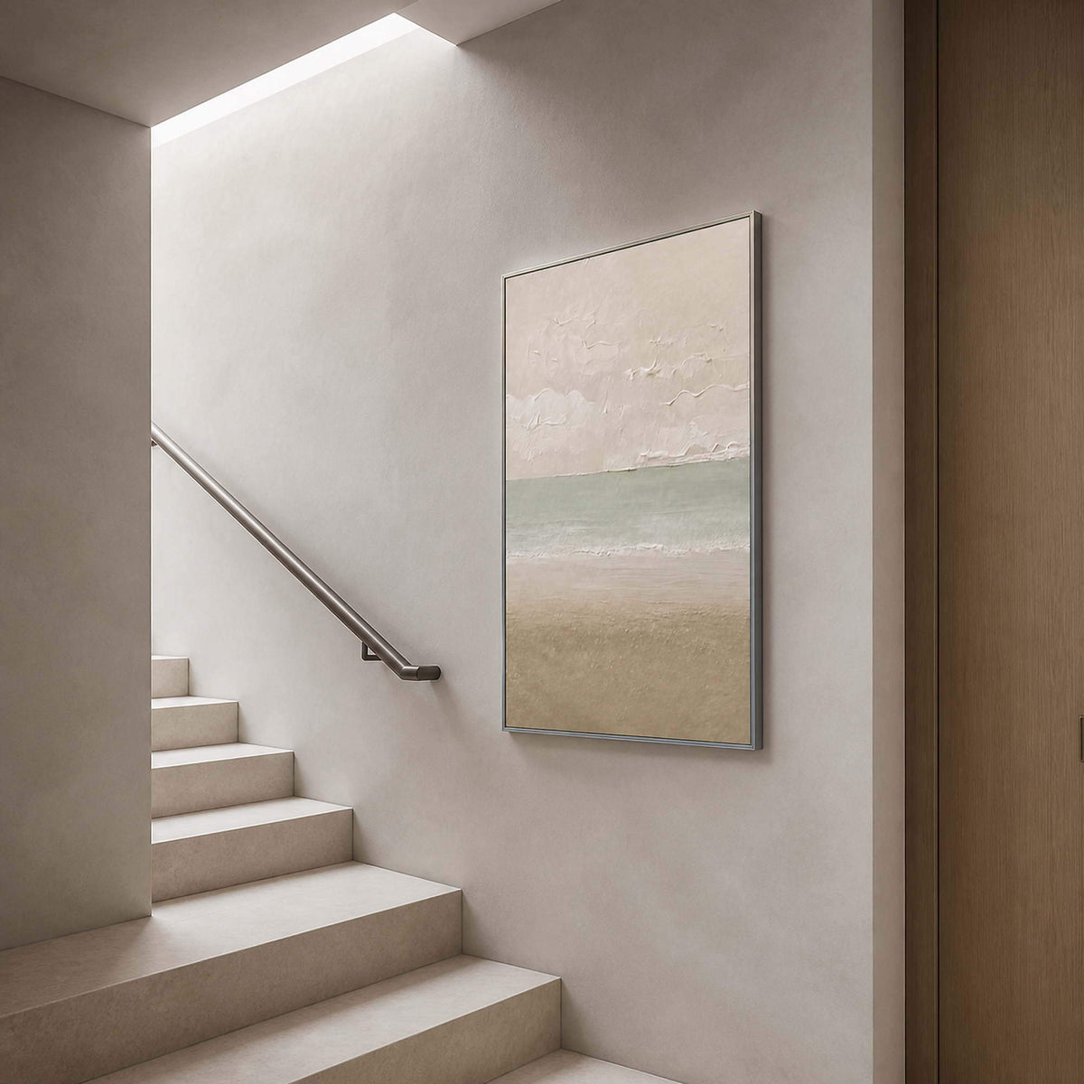 Tall coastal artwork viewed beside a pale minimalist staircase.
