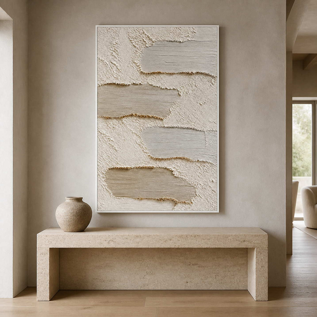 Textured neutral painting displayed above a sculptural stone entryway console.