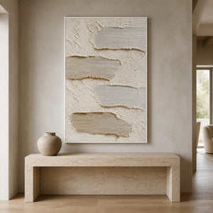 Textured neutral painting displayed above a sculptural stone entryway console.