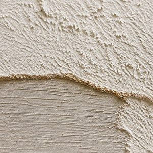 Close-up of raised ivory texture and softly brushed greige passages.