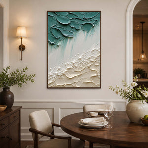 Green and ivory textured coastal wall art above a wood dining table.