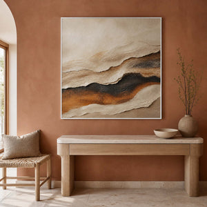 Textured abstract wall art displayed in a warm terracotta entryway.
