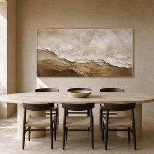 Earth-tone textured painting above a sculptural travertine dining table.