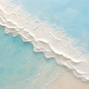 Close-up of thick white palette-knife foam over luminous turquoise water.