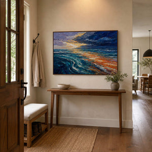 Blue and orange ocean wall art adds movement to a warm wood entryway.