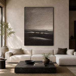 Dark coastal wall art displayed in a warm modern living room.