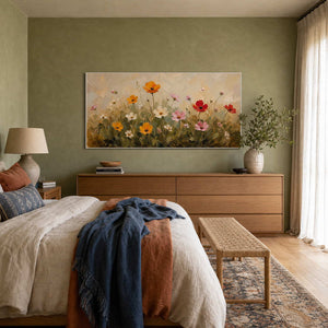 Colorful wildflower canvas brightening a calm green bedroom.