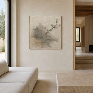 Textured wabi-sabi wall art displayed in a warm ivory stone living room.