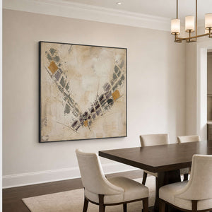 Weathered neutral abstract artwork above a dark wood dining table.