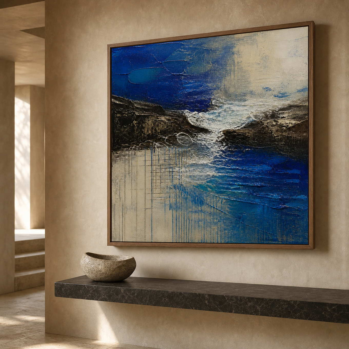 Textured blue coastal painting above a stone entryway console.