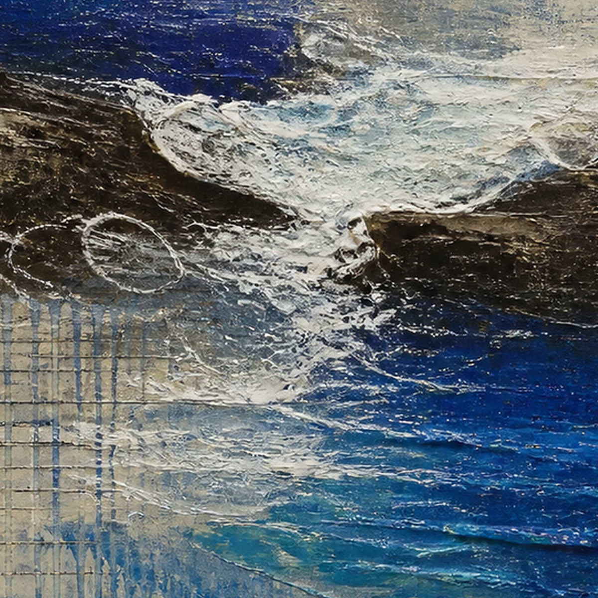 Close-up of raised white surf, dark rock, and cobalt blue texture.