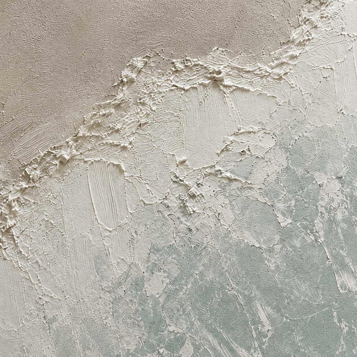 Close-up of raised ivory texture and pale blue brushwork.