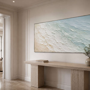Panoramic coastal canvas bringing airy color to a neutral entryway.