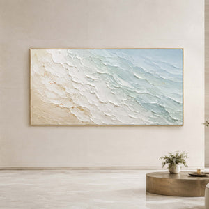 Textured coastal wall art displayed in a serene hotel lobby.