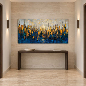 Gold and blue city artwork above a slim dark console between paired wall sconces.