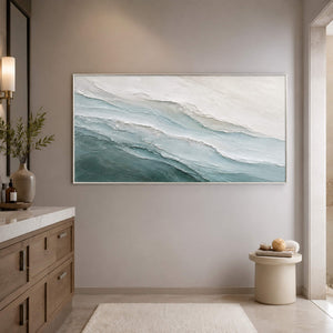 Soft blue coastal art in a spa-like bathroom.