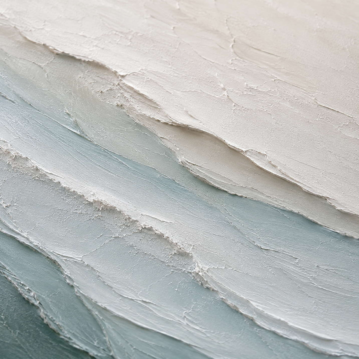 Close-up of soft blue and ivory textured paint.