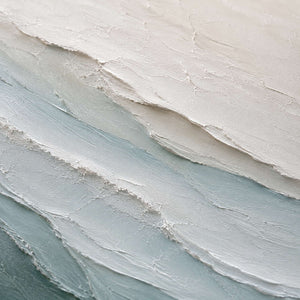 Close-up of soft blue and ivory textured paint.
