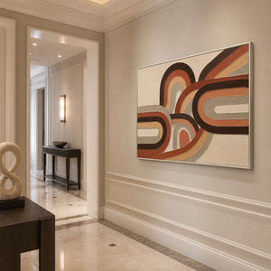 Textured boho wall art bringing warm curves to a bright entryway.