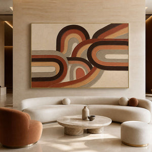 Textured warm abstract wall art displayed in a softly lit hotel lobby.