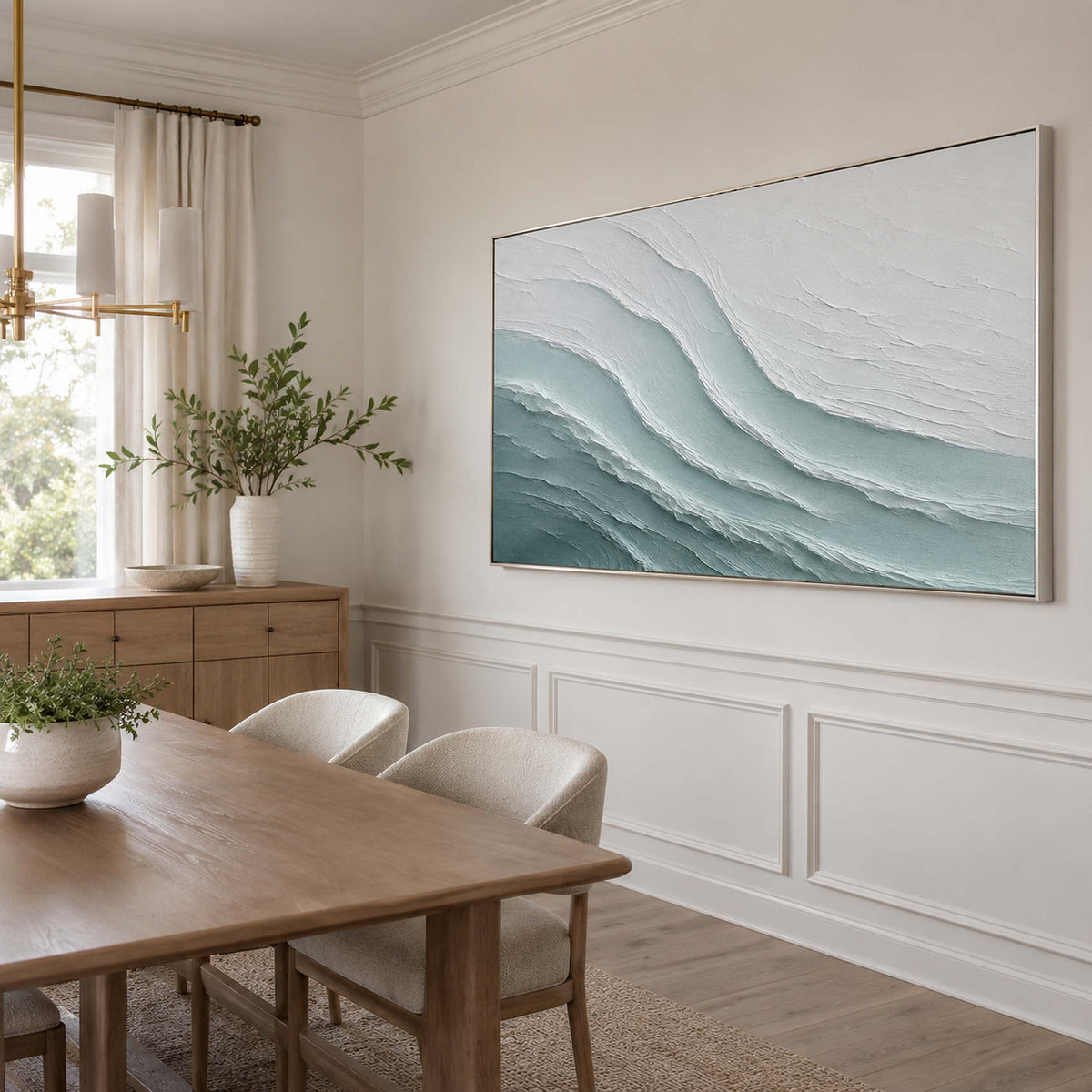Textured ocean artwork in a light modern dining room