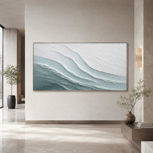 Layered ocean artwork in a serene modern hotel lobby