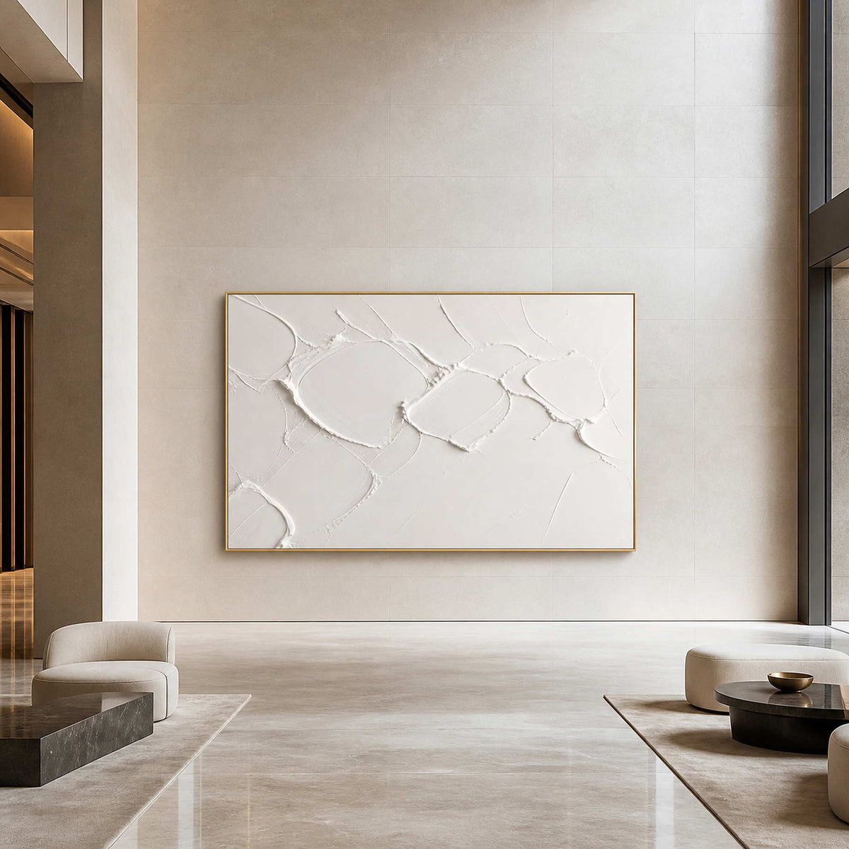 Textured white Wabi Sabi wall art displayed in an upscale hotel lobby.