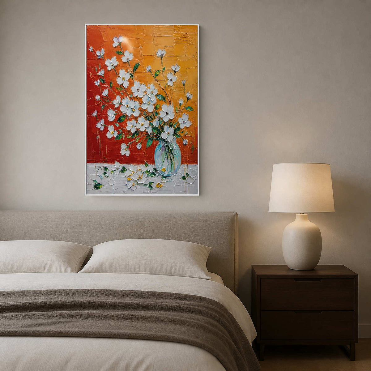 Textured white blossom painting beside a soft neutral bed.
