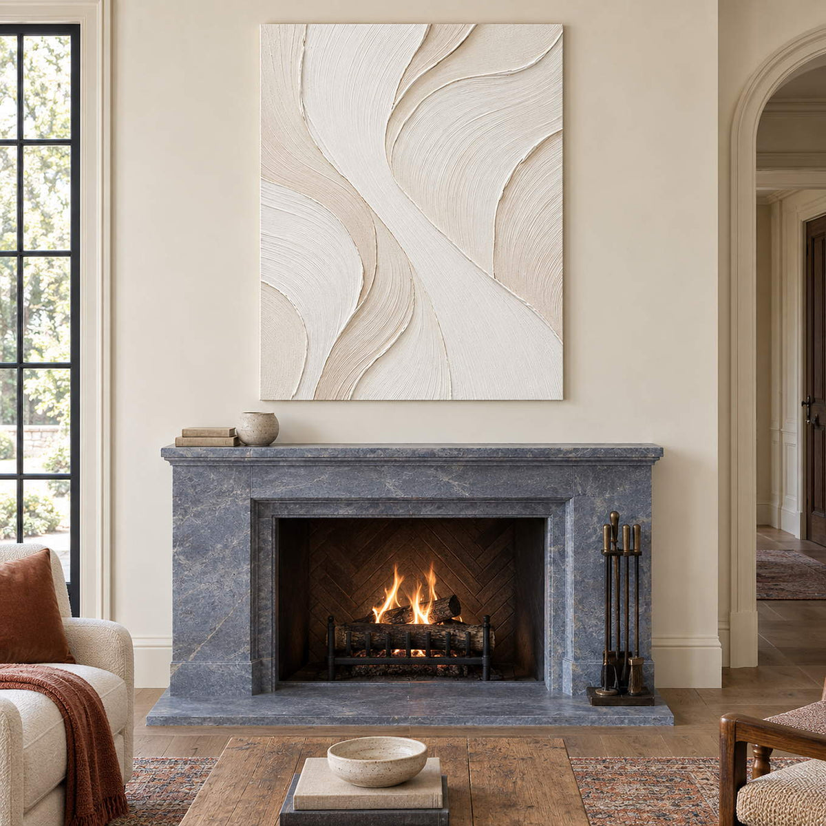 Hand-painted ivory abstract wall art with flowing cream relief and fine combed texture, displayed beside or above a fireplace without an outer frame.