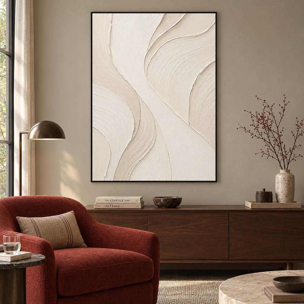 Hand-painted ivory abstract wall art with flowing cream relief and fine combed texture, displayed in a hotel lounge in a black frame.