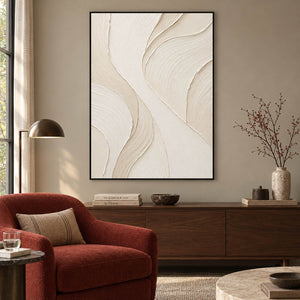 Hand-painted ivory abstract wall art with flowing cream relief and fine combed texture, displayed in a hotel lounge in a black frame.