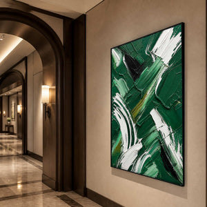 Vertical emerald and white abstract art in a warmly lit hallway.