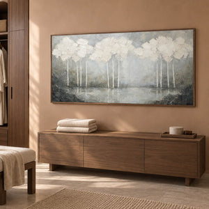 Hand-painted textured landscape wall art in white, pearl gray, and charcoal, displayed in a bathroom dry area in a brown wood frame.