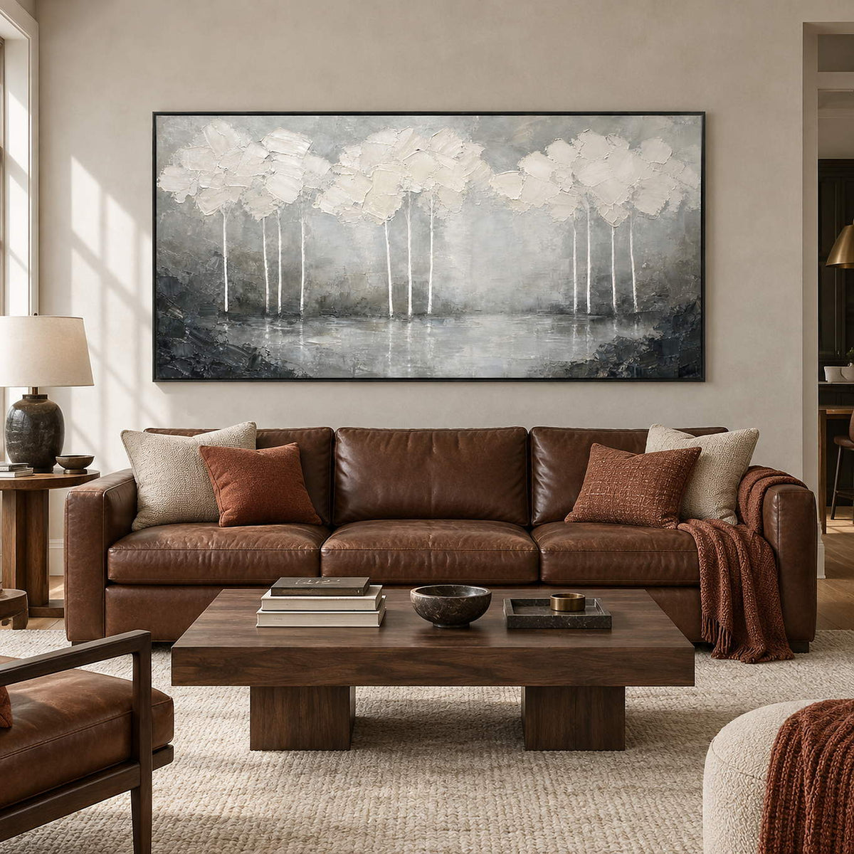 Hand-painted textured landscape wall art in white, pearl gray, and charcoal, displayed in a living room in a black frame.