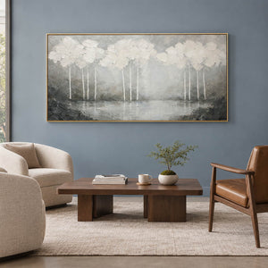 Hand-painted textured landscape wall art in white, pearl gray, and charcoal, displayed in a lounge in a gold frame.