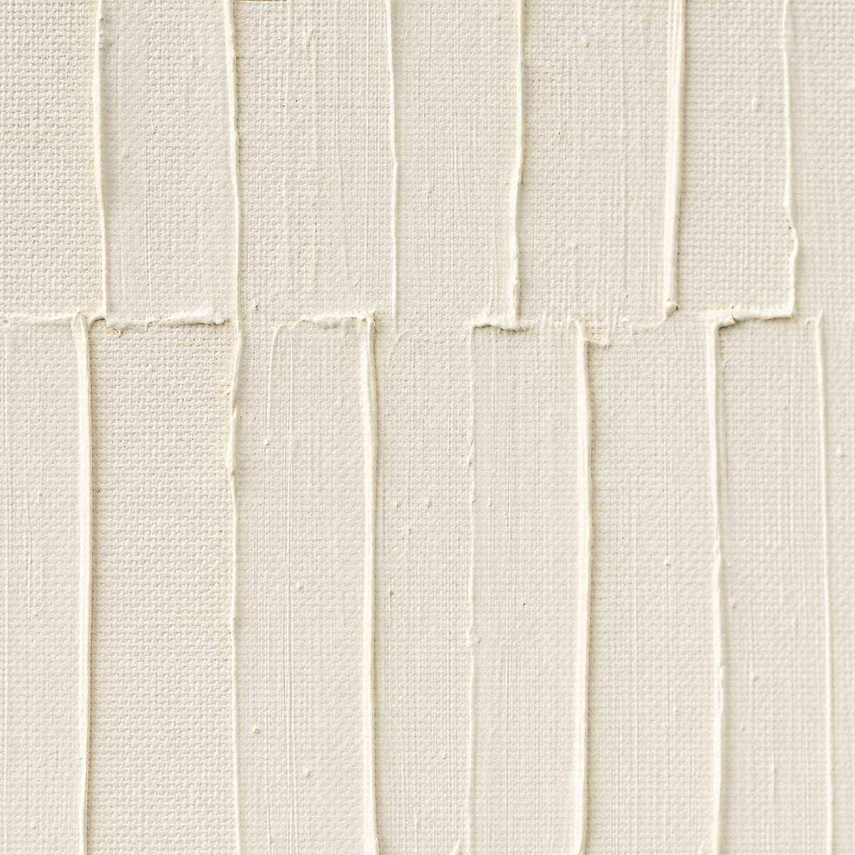 Close-up of raised ivory lines and hand-shaped plaster texture.