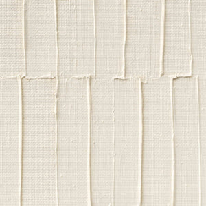 Close-up of raised ivory lines and hand-shaped plaster texture.