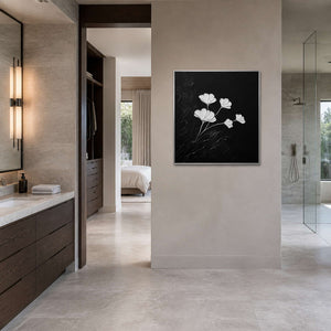 Monochrome floral painting viewed in a gray-white stone bathroom area.