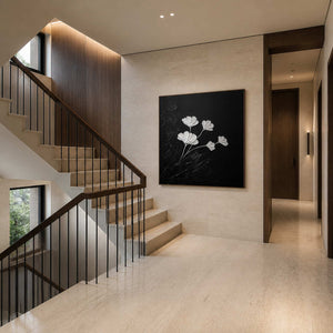 Black botanical canvas displayed beside a pale stone residential staircase.