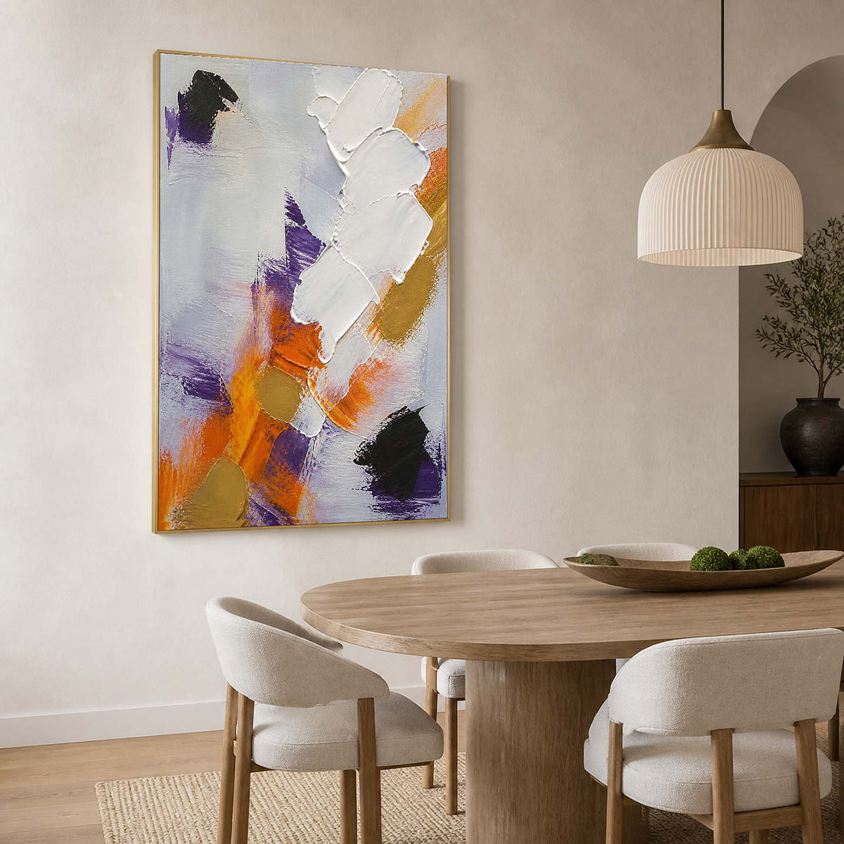 Refined neutral abstract wall art displayed beside a round wood dining table.