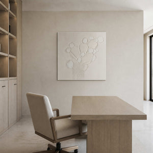 Minimalist floral wall art displayed in a light oak home office.
