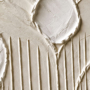 Close-up of rounded white relief edges and vertical palette-knife grooves.